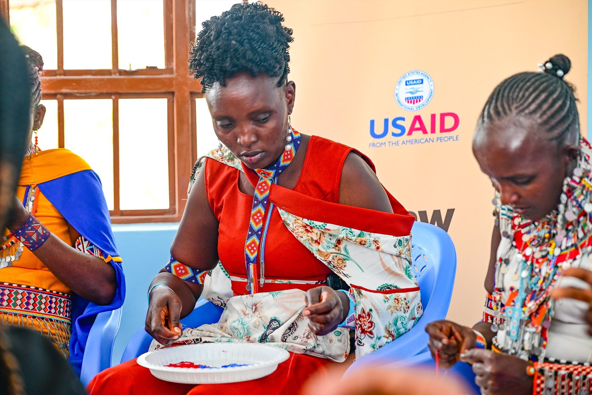 Maasai craftswoman assembling beaded ceremonial wristband